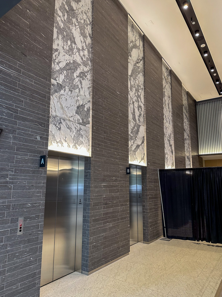 Large format porcelain tiles for wall panels above an elevator